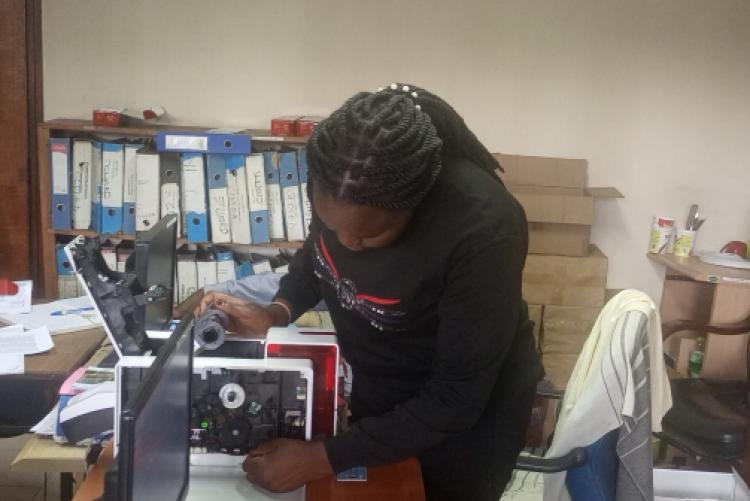 Academic ICT staff troubleshooting ID printer at Admission office